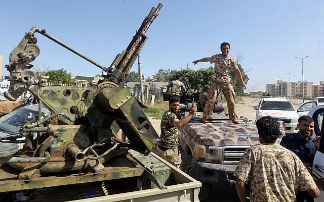 Forces loyal to Libya's Government of National Accord (GNA) gesture on April 18, 2019, after taking control of the area of al-Aziziyah, located some 40 kilometers south of the Libyan capital Tripoli, following fierce clashes with forces loyal to strongman Khalifa Haftar (Mahmud TURKIA / AFP)