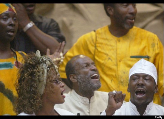 Whitney Houston and Bobby Brown sing with members of the Black Hebrews community during a ceremony in Houston's honor.